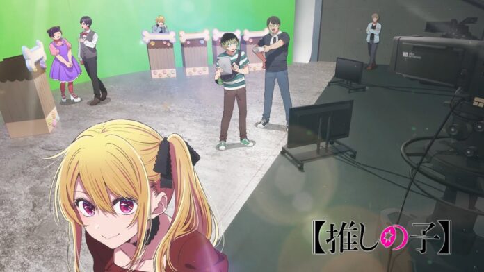 featured image for our news on Oshi no Ko Season 3 trailer. It shows Ruby Hoshino in the spotlight on the set of a variety show, with Aqua in the background,