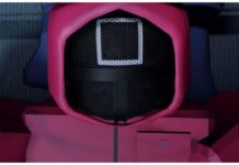 Ink Game Guns Guide – Plus Guard Tiers for Playable Guards! Feature image for our ink game guns guide showing a playable square guard up close as they lie on a bed