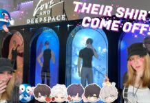 Come With Me To The Love and Deepspace 2nd Anniversary Popup in NYC! Feature image for our love and deepspace 2nd anniversary feature, showing the author in front of the heat changing acrylics with a bunch of emote decor on the front